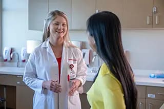 Surgeon talks with patient in medical room