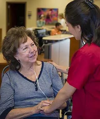 health professional helps elderly patient
