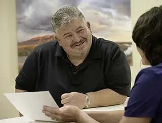 Man looks over paperwork with a medical professional.