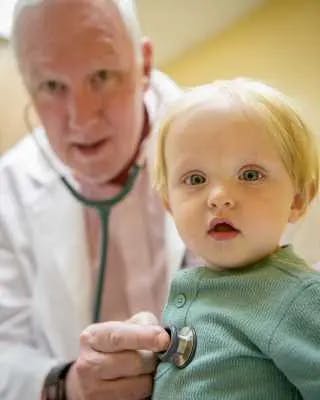 Doctor and child looking at camera