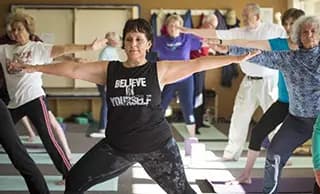 A class of people doing stretches.