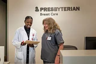 Presbyterian Breast Care surgical oncologist and nurse navigator review lab results to help create a patient’s cancer treatment plan.