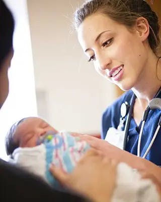 Woman handing off newborn