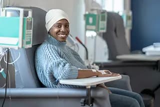 Presbyterian gynecologic oncology patient is shown, sitting in a comfortable chair, while receiving chemotherapy as part of her cancer treatment plan.