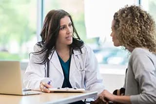 Doctor and patient talk at a table