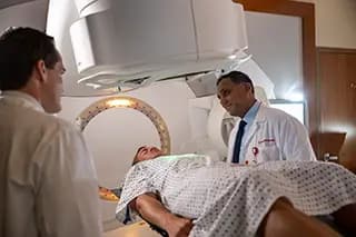Presbyterian radiation oncologists using targeted radiation therapy to help treat a patient’s cancer.