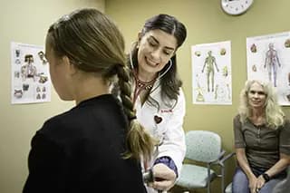 Doctor listens to child's breathing